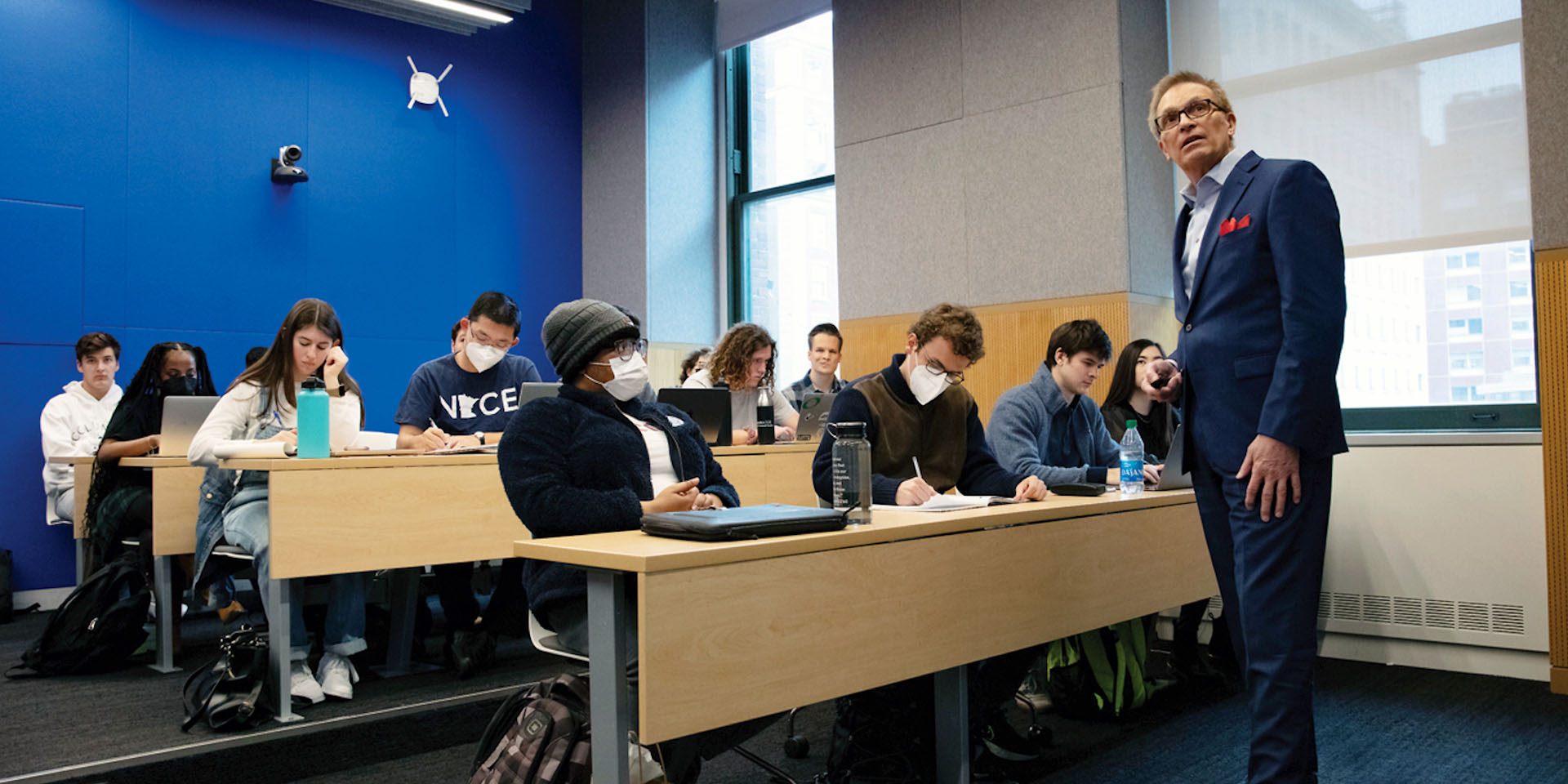 Dean Valentini in class teaching a small group of students