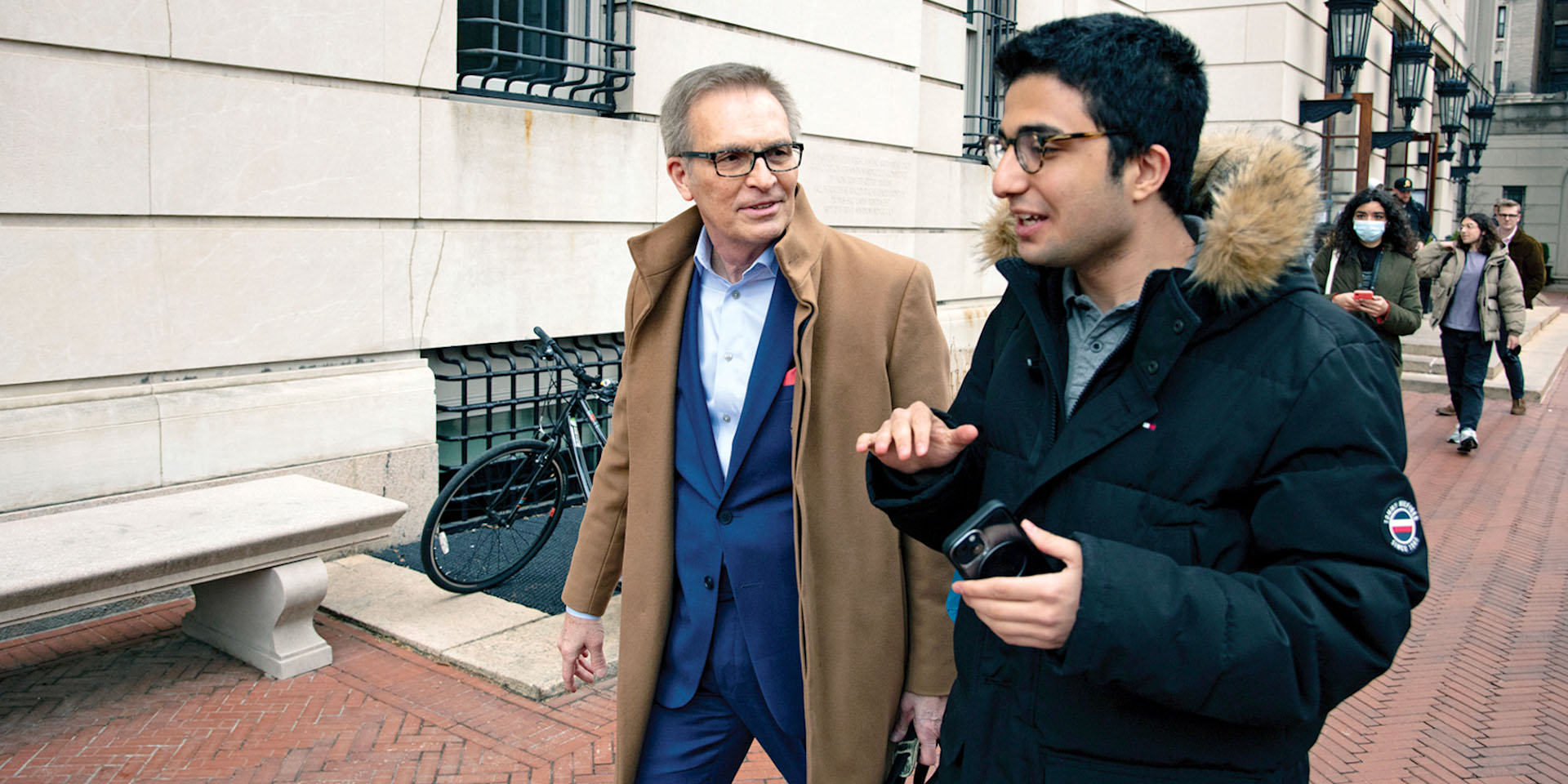 Dean Valentini speaking with a student outside Hamilton Hall